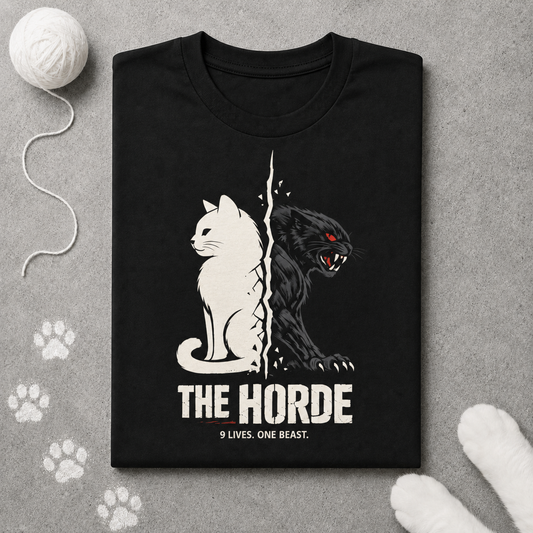 Black t-shirt with cat and panther design and 'The Horde' text on a gray surface with paw prints.
