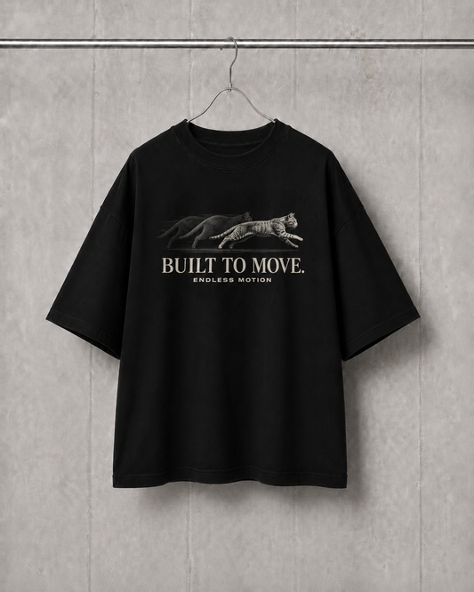 Black t-shirt with graphic design and text on a gray wall background