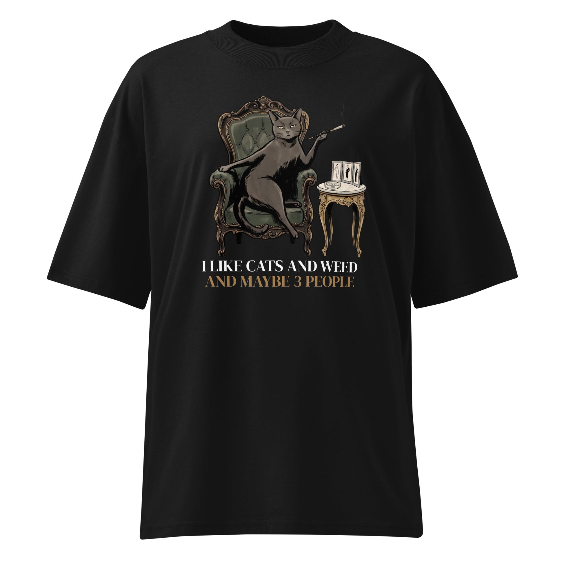 Black t-shirt with a graphic of a cat, chair, and table, and text 'I like cats and weed and maybe 3 people' on a white background.