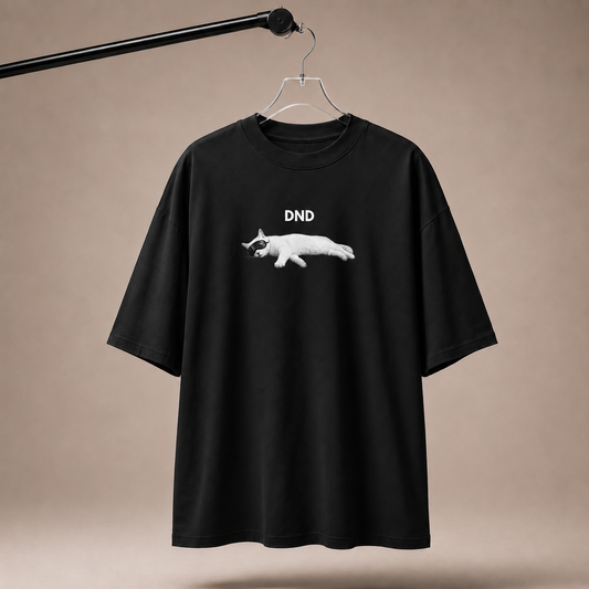 Black t-shirt with a white graphic and 'DND' text on a beige background