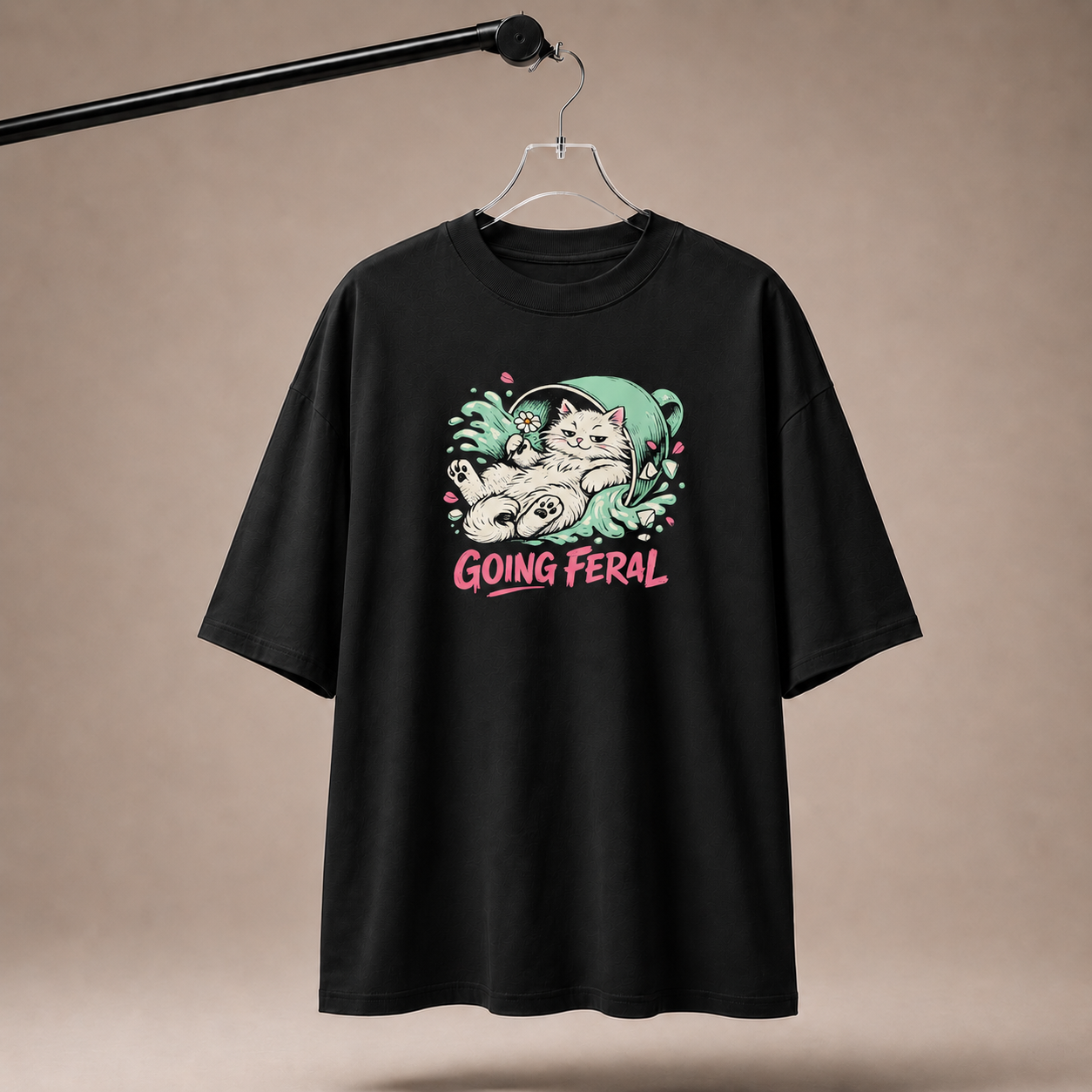 Black t-shirt with a graphic design and text 'Going Feral' on a beige background