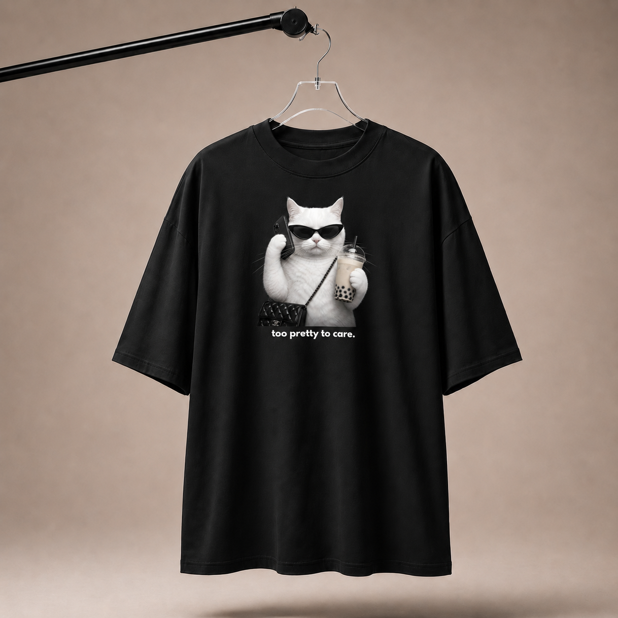 Black t-shirt with a cat graphic and text on a beige background