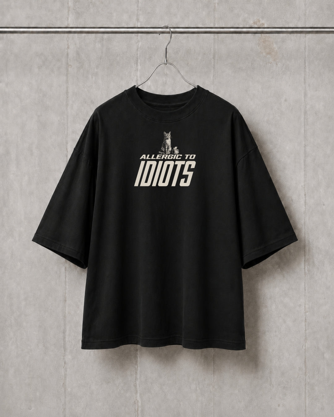 Black t-shirt with text on a gray textured wall