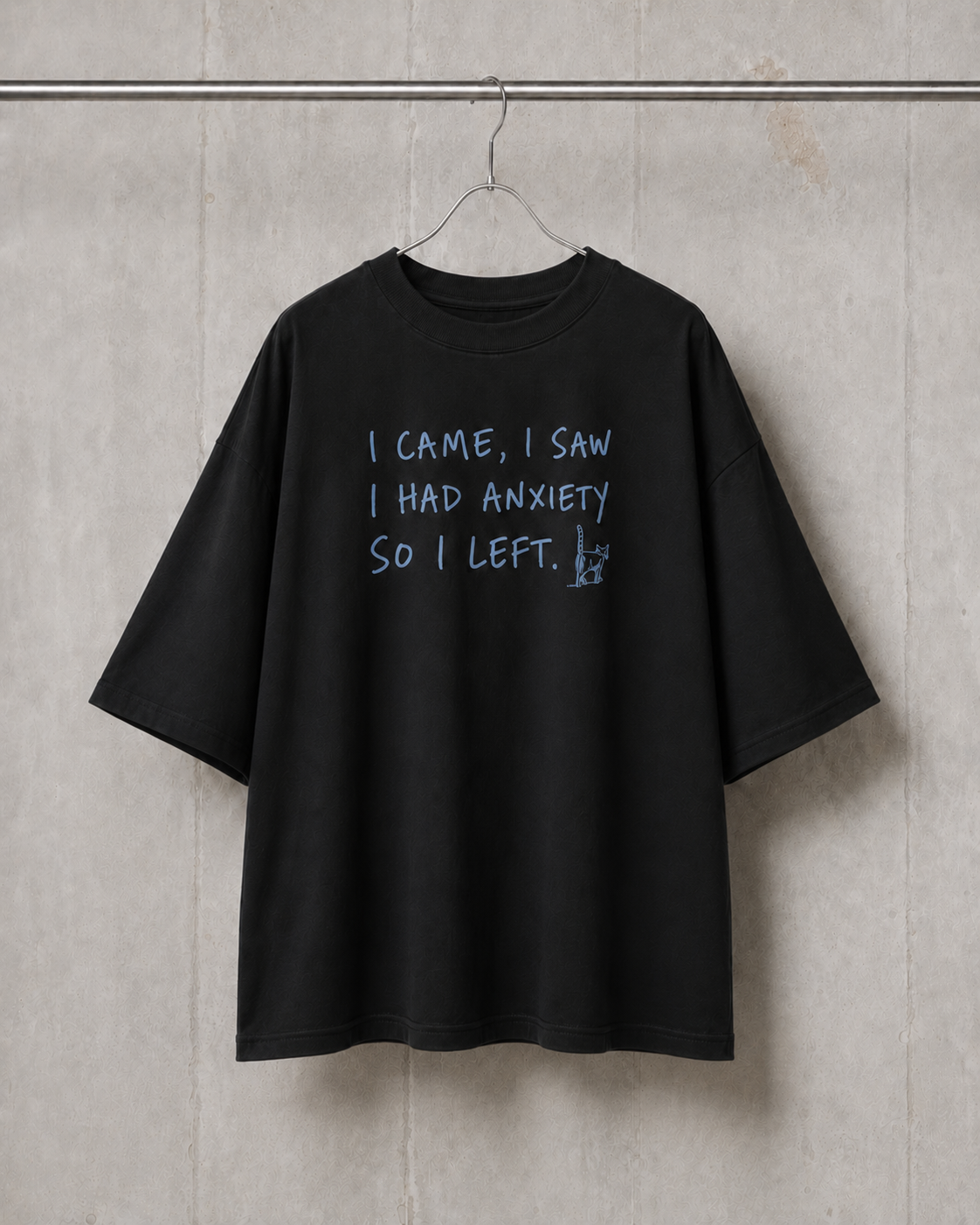 Black t-shirt with text on a gray wall