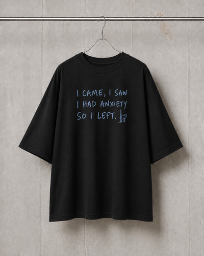 Black t-shirt with text on a gray wall