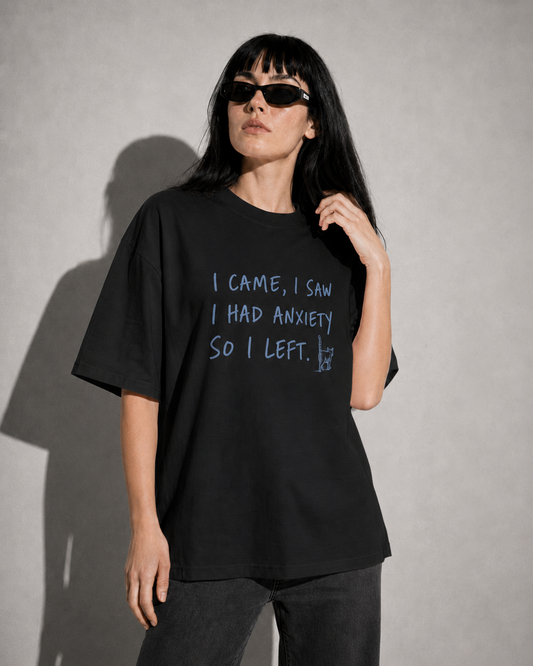 Person wearing a black t-shirt with text against a gray background