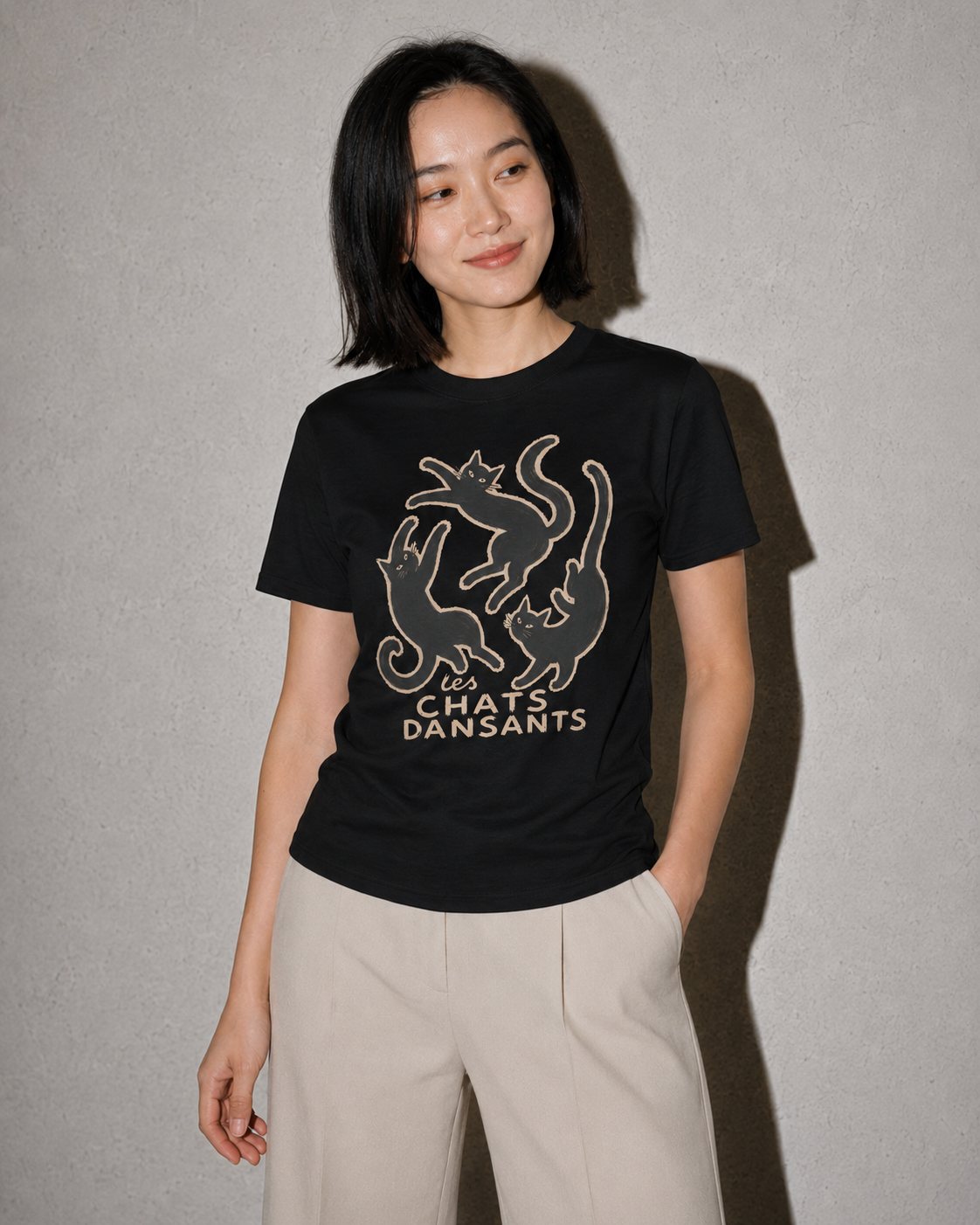 Person wearing a black t-shirt with a graphic design and text on a plain background