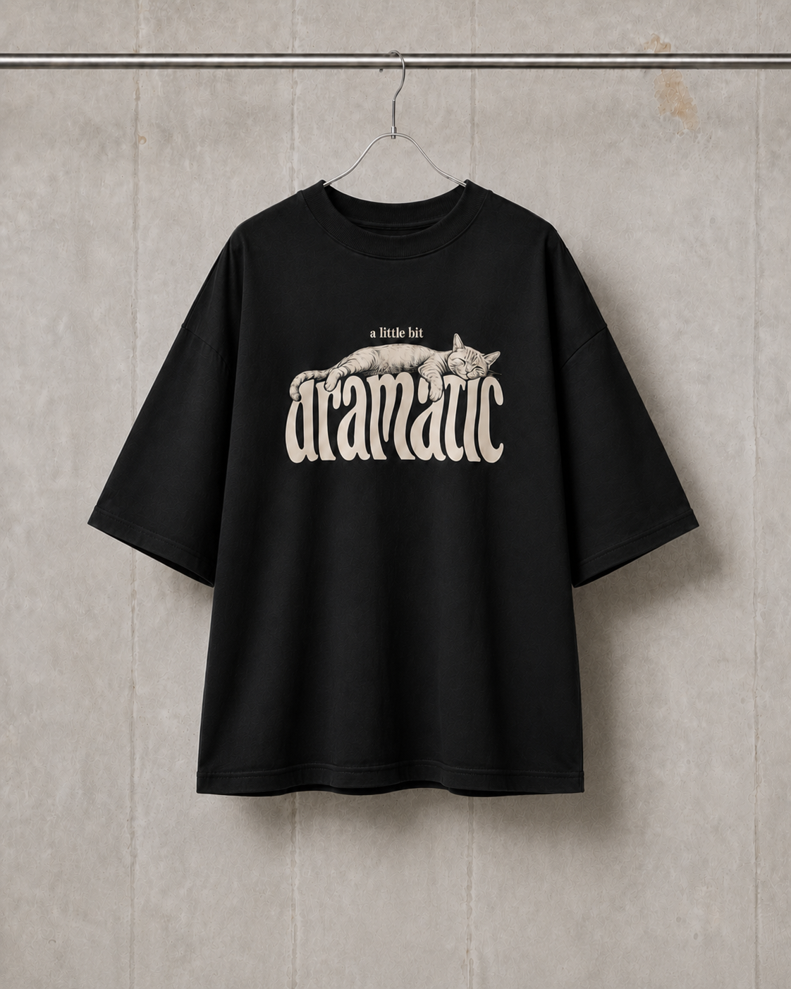 Black t-shirt with graphic design and text on a textured wall background