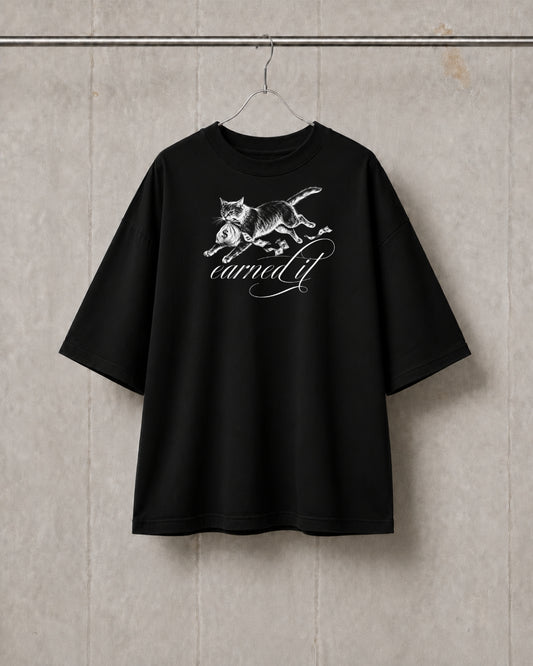 Black t-shirt with a white graphic design on a textured wall background