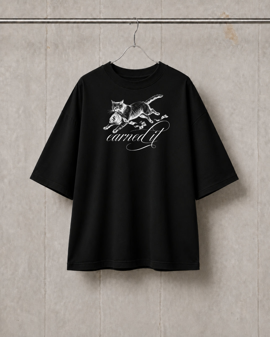 Black t-shirt with a white graphic design on a textured wall background