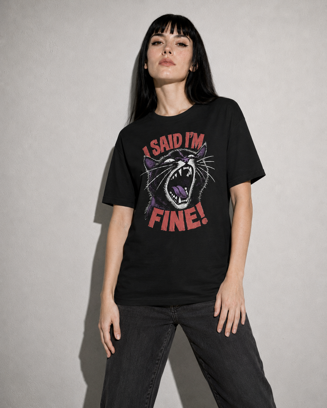 Person wearing a black t-shirt with a graphic design and text against a plain background