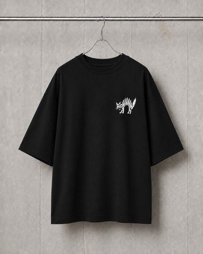 Black t-shirt with a white graphic on a hanger against a gray concrete wall