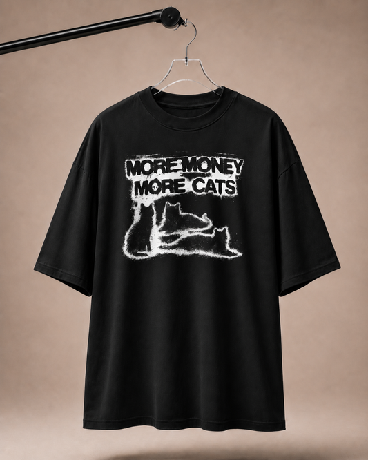 Black t-shirt with 'More Money More Cats' text and graphic on a beige background