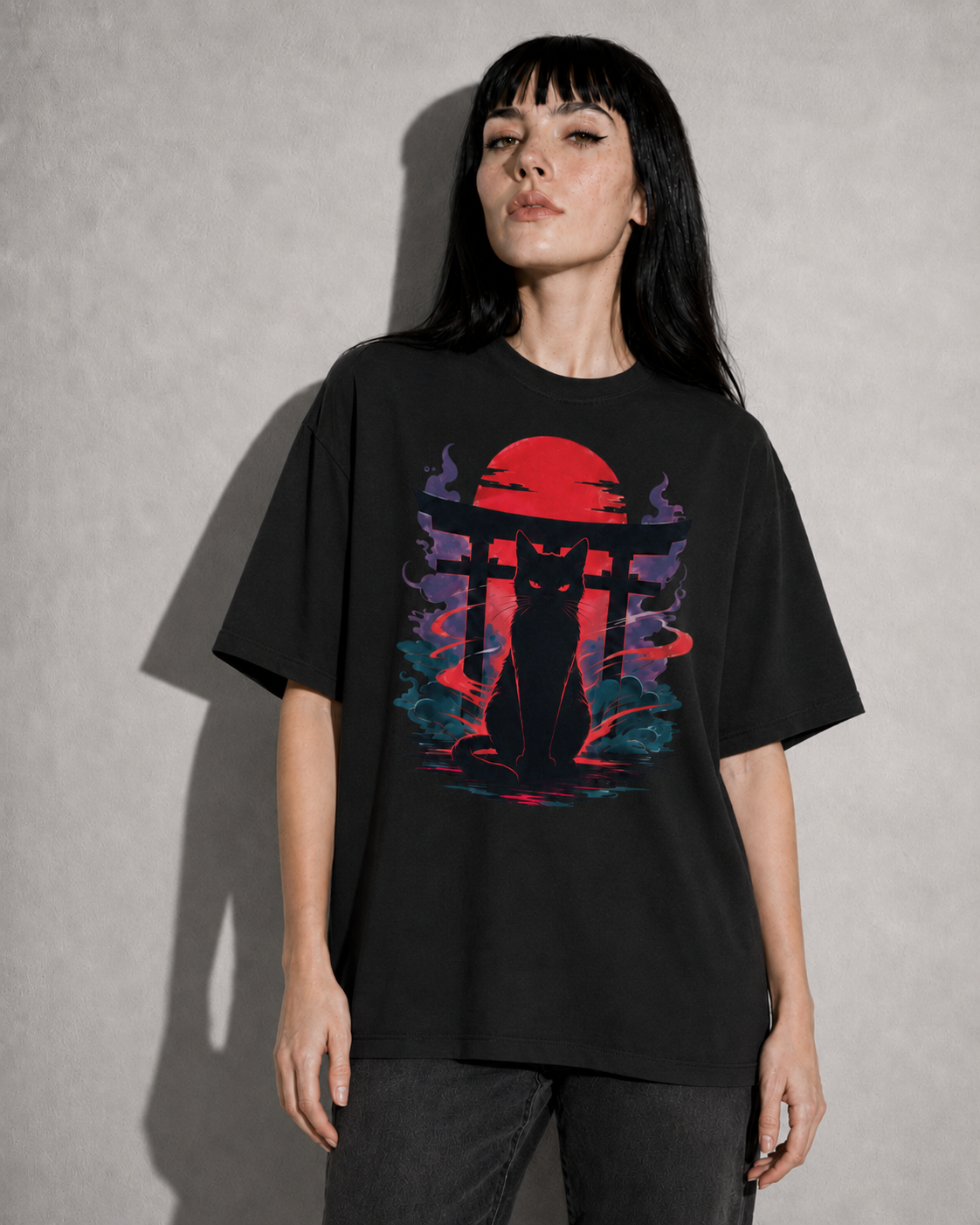 Person wearing a black t-shirt with a colorful graphic design on a plain background