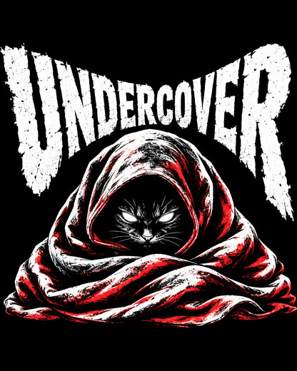 Cat in a hooded cloak with 'UNDERCOVER' text on a black background